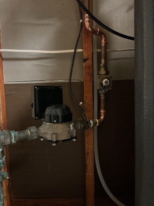 Responded to emergency basement flooding situation with arrival between 4-8. Upon investigation, identified source of leak as a pinhole failure in three-quarter inch copper 90-degree elbow fitting located immediately after the water meter. Main water line to house was shut off to prevent additional flooding and property damage. 

Assessed the affected plumbing system, which displayed significant age-related corrosion and verdigris patina on copper piping throughout the installation. The failed section exhibited compromised pipe integrity due to oxidation and deterioration. Removed the damaged three-quarter inch 90-degree fitting and surrounding compromised pipe section. Installed new copper pipe section with proper fittings to restore water supply line integrity. All connections were properly soldered and pressure-tested to ensure leak-free operation. Restored main water supply to residence and verified system functionality with no additional leaks detected.