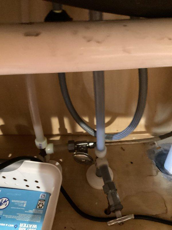 Completed comprehensive plumbing inspection of residential property, arriving at rescheduled 6pm appointment time. Thoroughly examined utility room gas line assembly including yellow CSST flexible gas piping with brass fittings and red shut-off valve, as well as under-sink plumbing infrastructure featuring supply line connections, P-trap configuration, and fixture mounting. Documented all findings with photographic evidence for record-keeping purposes.