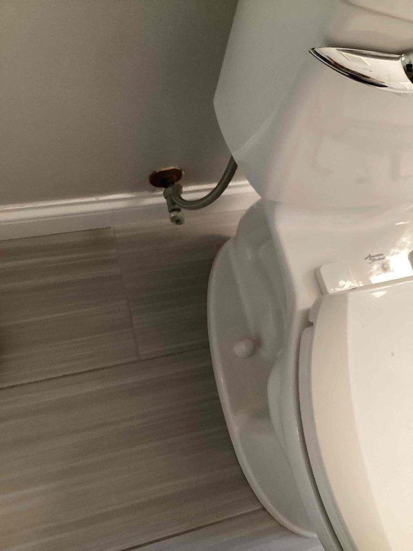 Responded to service call for two malfunctioning toilets. In the upstairs guest bathroom, diagnosed and resolved a high-pitched noise caused by a loose packing nut on the angle stop and a loose toilet supply line; tightened both components to restore proper function. In the master bathroom, investigated a toilet with intermittent water leaking from the tank into the bowl. Determined the issue was not related to the flapper or flush valve, indicating a more significant internal tank component failure. Provided estimate for complete toilet replacement as the most effective repair solution. Photographed affected fixtures for documentation purposes.