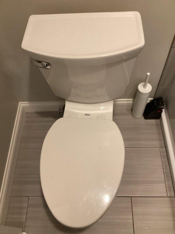 Responded to service call for two malfunctioning toilets. In the upstairs guest bathroom, diagnosed and resolved a high-pitched noise caused by a loose packing nut on the angle stop and a loose toilet supply line; tightened both components to restore proper function. In the master bathroom, investigated a toilet with intermittent water leaking from the tank into the bowl. Determined the issue was not related to the flapper or flush valve, indicating a more significant internal tank component failure. Provided estimate for complete toilet replacement as the most effective repair solution. Photographed affected fixtures for documentation purposes.
