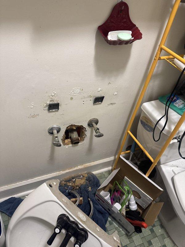 Responded to emergency plumbing call for broken lavatory waste line located within bathroom wall cavity beneath sink. Upon arrival after 9:00 AM, accessed the damaged pipe through wall opening prepared by property owner. Inspected the compromised drain line and confirmed complete failure of the lavatory waste pipe, which exhibited severe corrosion and structural deterioration. Removed the damaged section of waste line and replaced with new piping materials to restore proper drainage function. Completed all necessary connections to ensure code-compliant installation and verified system integrity through water flow testing.