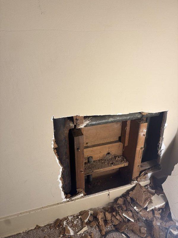 Responded to emergency plumbing call for broken lavatory waste line located within bathroom wall cavity beneath sink. Upon arrival after 9:00 AM, accessed the damaged pipe through wall opening prepared by property owner. Inspected the compromised drain line and confirmed complete failure of the lavatory waste pipe, which exhibited severe corrosion and structural deterioration. Removed the damaged section of waste line and replaced with new piping materials to restore proper drainage function. Completed all necessary connections to ensure code-compliant installation and verified system integrity through water flow testing.