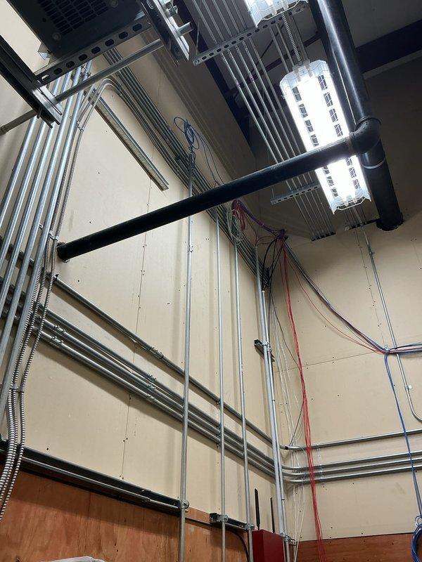Installed three dedicated circuits for kitchen and laundry appliances: a 50-amp circuit with approximately 50 feet of wire run for electric stove, a 20-amp circuit with 50-foot run for dishwasher, and a 20-amp circuit with 50-foot run for combination washer/dryer unit. Ran metallic flexible conduit and wiring through utility room, securing all conductors to wall and ceiling structures per code requirements. Installed appropriate receptacles and terminations for each appliance circuit, ensuring proper grounding and overcurrent protection at the electrical panel.