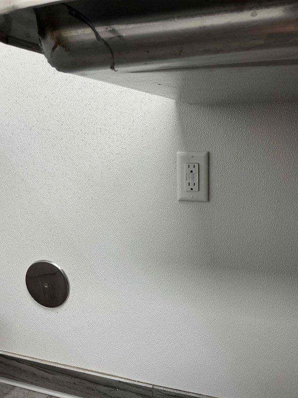 Installed three dedicated circuits for kitchen and laundry appliances: a 50-amp circuit with approximately 50 feet of wire run for electric stove, a 20-amp circuit with 50-foot run for dishwasher, and a 20-amp circuit with 50-foot run for combination washer/dryer unit. Ran metallic flexible conduit and wiring through utility room, securing all conductors to wall and ceiling structures per code requirements. Installed appropriate receptacles and terminations for each appliance circuit, ensuring proper grounding and overcurrent protection at the electrical panel.