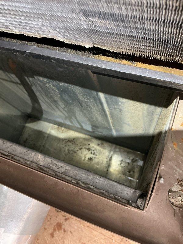 Responded to service call for AC unit leaking water and emitting foul odor. Diagnosed clogged condensate drain line caused by restricted airflow from overly restrictive air filter. Vacuumed and cleared drain line to restore proper drainage. Inspected evaporator coil and drain pan, noting accumulated debris consistent with reduced airflow conditions. Recommended replacement with MERV 3-5 rated filter to prevent future drain line blockages and maintain adequate system airflow. Unit tested and operating properly upon departure.