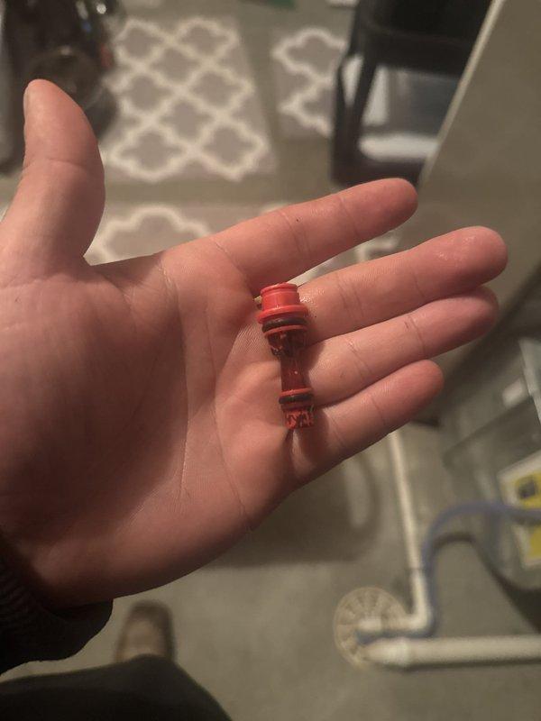 Responded to service call for water softener with brine tank continuously filling. Diagnosed faulty injector assembly causing improper brine draw and regeneration cycle malfunction. Removed and replaced defective red plastic injector component with new unit, restoring proper water softener operation and preventing brine tank overflow.