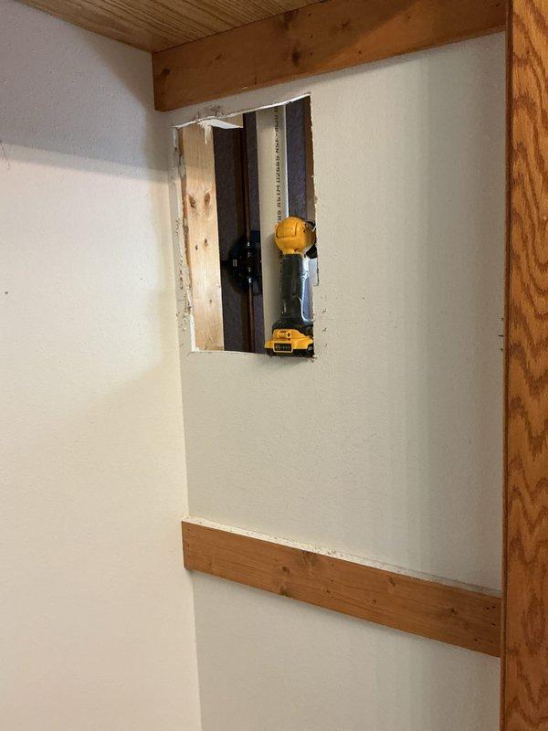 Responded to emergency call for burst pipe causing ceiling leak. Upon arrival, found water supply to house already shut off. Inspection revealed leak originating from hot water side where copper pipe connects to valve. Accessed plumbing through wall cavity to assess damage and source of leak. Capped the affected copper line to stop water intrusion and prevent further damage to ceiling and surrounding areas. Documented existing plumbing configuration including copper pipes, PEX connections, and valve assembly. Provided detailed estimate for permanent repair of the damaged hot water line and restoration of water service.