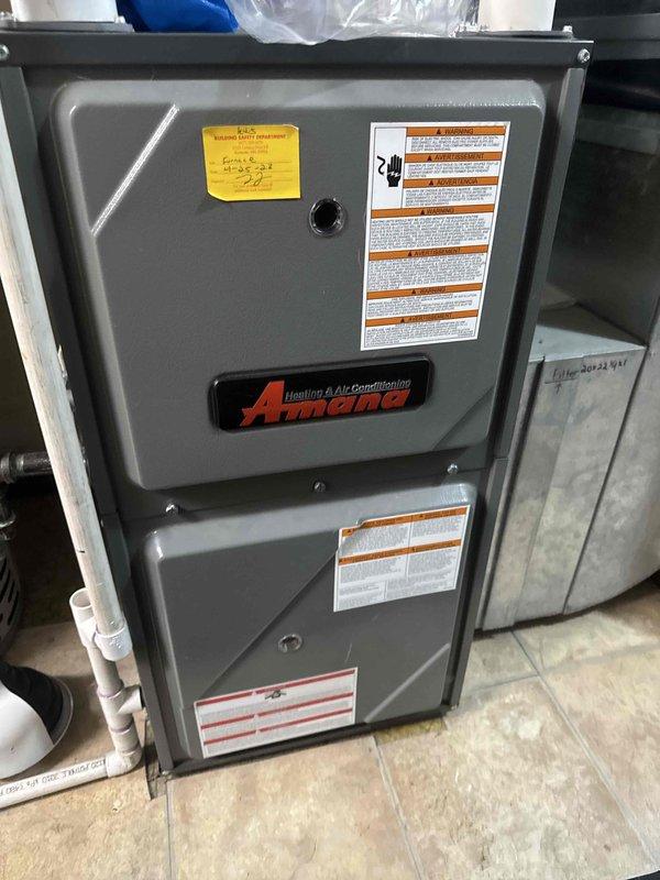 Responded to no-heat call with furnace leaking water and making gurgling noises. Found inducer assembly completely full of water caused by undersized 2" 90° elbow in condensate drainage system. Removed defective drain fitting and replaced with properly-sized component under Amana 10-year parts warranty. Verified proper drainage flow, tested inducer motor operation, and confirmed unit returned to normal heating operation.