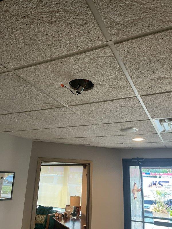 Responded to service call for flickering and non-functioning light fixtures in commercial office space. Diagnosed burnt out recessed can lights in drop ceiling system and successfully replaced four defective recessed light fixtures, restoring full illumination to the area.