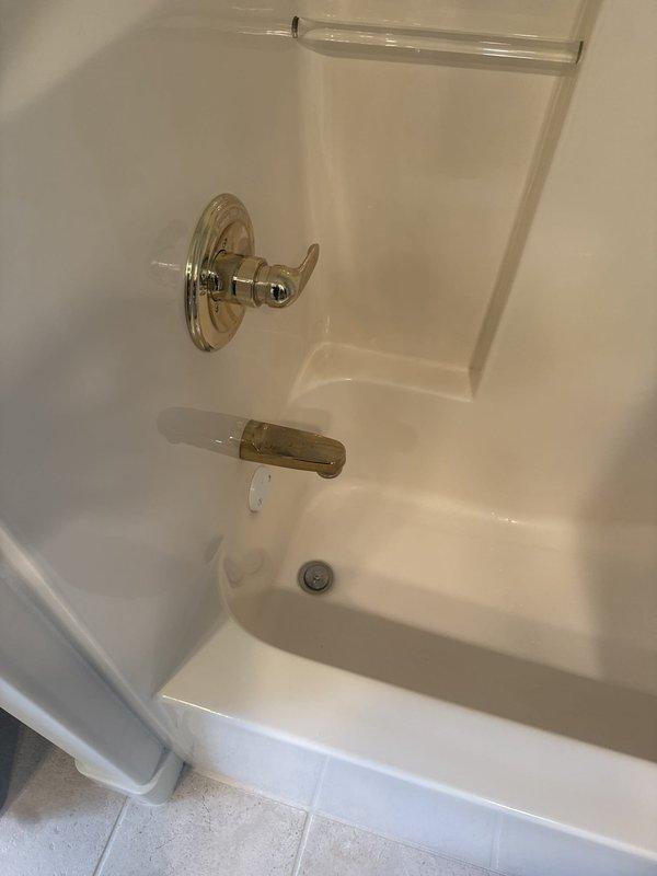 Responded to service call for multiple plumbing issues including leaking faucets in kitchen and bathroom areas. Performed assessment of bathroom fixtures, including bathtub/shower assembly with chrome single-handle faucet and tub spout showing signs of wear and discoloration, as well as dual-sink vanity equipped with gold-finished single-handle faucets. Completed faucet replacements in kitchen and bathroom to resolve leaking conditions. Also evaluated 24-year-old water heater exhibiting loud operational noises and recommended replacement due to age and performance issues.