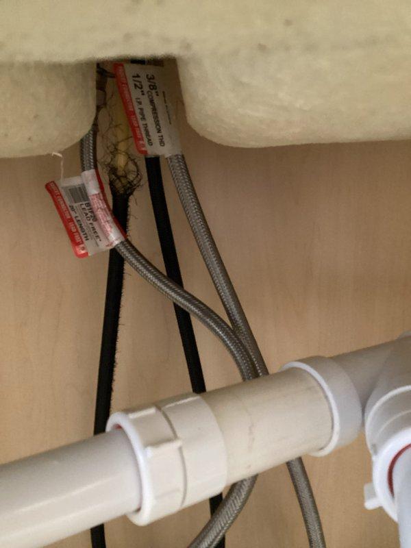Responded to service call for leak under kitchen sink. Upon arrival, identified source of leak at existing kitchen faucet. Removed old kitchen faucet assembly from countertop mounting. Installed new customer-provided kitchen faucet with tall spout and side spray attachment onto granite composite countertop. Connected flexible braided stainless steel supply lines to hot and cold water supply valves. Secured supply lines with proper fasteners and verified all connections were tight and leak-free. Tested new faucet installation for proper operation and confirmed no leaks present under sink or at mounting points. Left work area clean with fully functional faucet assembly.
