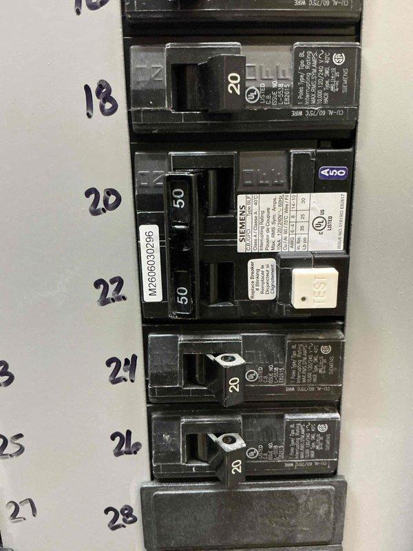 Completed electrical panel work by installing the final GFCI circuit breaker in the panel and finishing the wiring connections. Tested the range circuit to verify proper operation and confirmed all breaker installations met code requirements. The GFCI breaker was properly labeled and is now protecting the designated circuit as intended.
