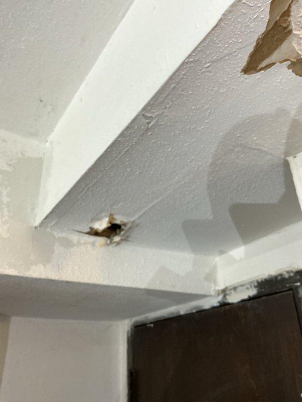 Responded to service call for AC condensation issues affecting garage ductwork. Upon arrival, inspected the condensation damage on ceiling and wall surfaces where moisture from the ductwork had caused deterioration of drywall materials. Documented extensive water damage with visible holes in ceiling material and compromised paint surfaces near duct installation. Photos captured for management review to determine appropriate remediation approach. Customer notified that recommendation and course of action will be coordinated with management regarding condensation mitigation solutions for the garage ductwork system.