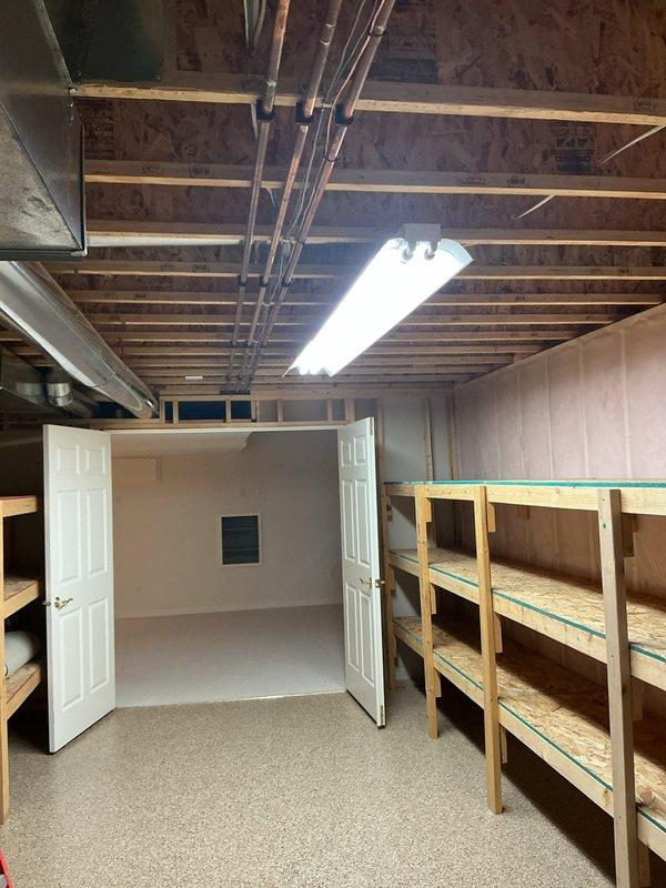 Completed basement lighting upgrades including retrofitting three 8-foot fluorescent strip lights to LED technology. Replaced outdated under-cabinet fluorescent fixtures in laundry area with new LED fixtures, removed upper cabinet lights, and properly secured all associated wiring. Installed new smoke detector to bring system up to current safety standards.