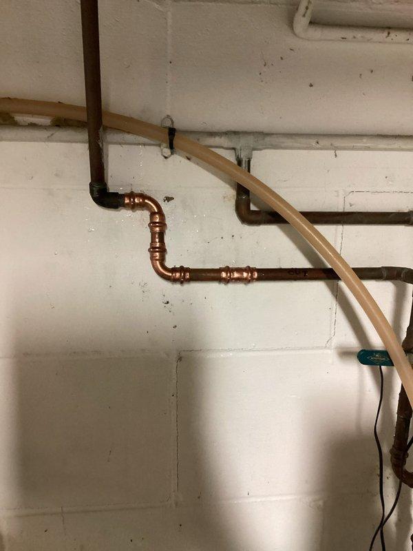 Responded to a pinhole leak on a 1/2" copper water line exiting the water softener. Located the compromised section of pipe, cut out the damaged portion, and installed new copper piping with proper fittings and joints. System was tested and restored to full operational status with no further leaks detected.
