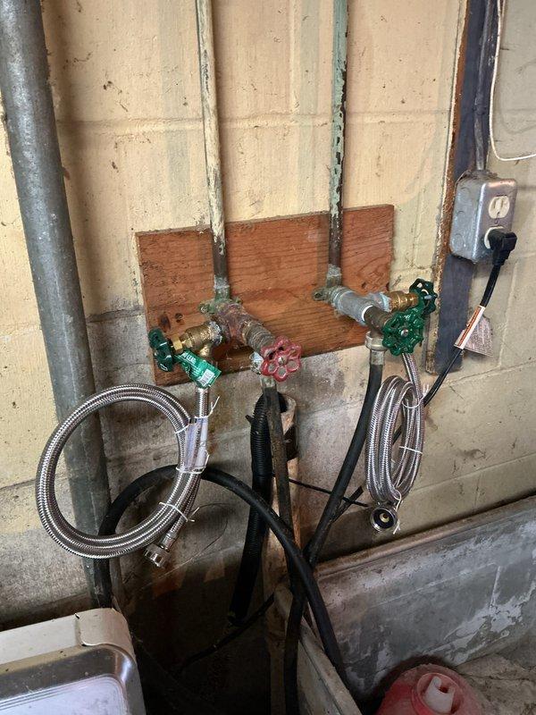 Responded to service call for slow-draining tub and corroded washing machine water supply valves. Upon inspection, found two shut-off valves connecting to the washing machine supply lines were severely corroded and required replacement. Successfully removed old corroded valves and installed new shut-off valves with wheel handles for both hot and cold water supply lines. Connected flexible braided stainless steel supply lines to the new valves and verified proper water flow and shutoff functionality. Tested washing machine connections for leaks and confirmed all plumbing connections were secure and operational.