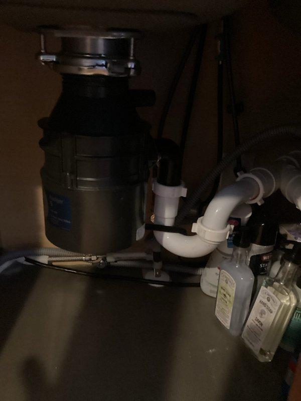 Responded to service call for non-operational garbage disposal unit. Upon inspection, identified jamming issue preventing disposal from functioning. Successfully cleared blockage from drum using disposal wrench, restoring unit to proper working condition. Verified all components including mounting assembly, P-trap configuration, and drainage connections were secure and functioning properly upon completion.