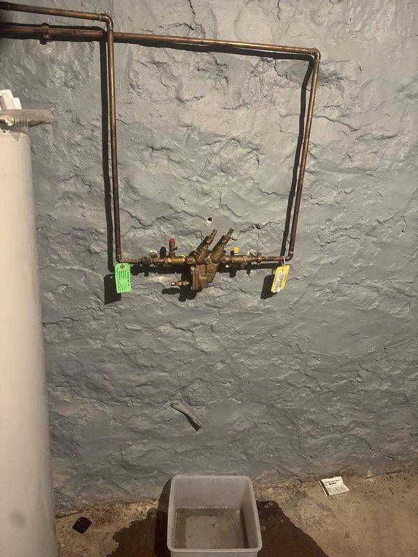 Responded to building-wide low water pressure complaint. Investigated plumbing system and identified clogged cartridges in the main brass valve manifold assembly as the source of reduced flow throughout the facility. Removed and replaced affected cartridges, restoring proper water pressure to all fixtures. Verified system operation at kitchen sink and confirmed adequate pressure restoration.