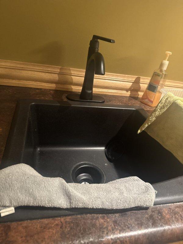 Responded to drainage issue where kitchen sink water was backing up into bar sink. Upon arrival and inspection, tested drainage system and found no active clog or obstruction present. Verified proper water flow through both sink drains with no backup occurring during service visit. System functioning normally at time of inspection.