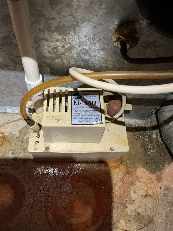 Responded to service call for water leakage issue in HVAC system. Upon arrival, discovered water accumulation on floor originating from downflow furnace with active leak at collector box. Inspected condensate drainage system including condensate pump and associated PVC piping, noting rust staining on concrete floor beneath unit indicating ongoing moisture problem. Documented furnace components, gas line connections, ductwork joints, and internal mechanical assemblies through comprehensive photographic documentation. Provided replacement estimate and coordinated with project management for furnace replacement due to extent of collector box failure.