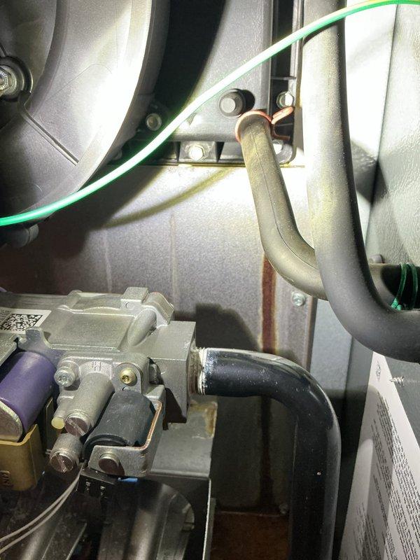 Responded to service call for water leakage issue in HVAC system. Upon arrival, discovered water accumulation on floor originating from downflow furnace with active leak at collector box. Inspected condensate drainage system including condensate pump and associated PVC piping, noting rust staining on concrete floor beneath unit indicating ongoing moisture problem. Documented furnace components, gas line connections, ductwork joints, and internal mechanical assemblies through comprehensive photographic documentation. Provided replacement estimate and coordinated with project management for furnace replacement due to extent of collector box failure.