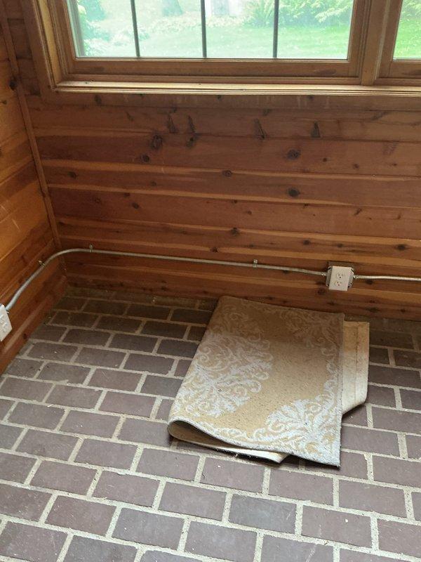 Completed electrical installation in four-season porch, including fishing wire from existing garage outlet to add new electrical outlets on wood-paneled walls. Successfully installed ceiling fan and additional light fixture, requiring tall ladder for overhead work. All fixtures and outlets tested and operational upon completion.