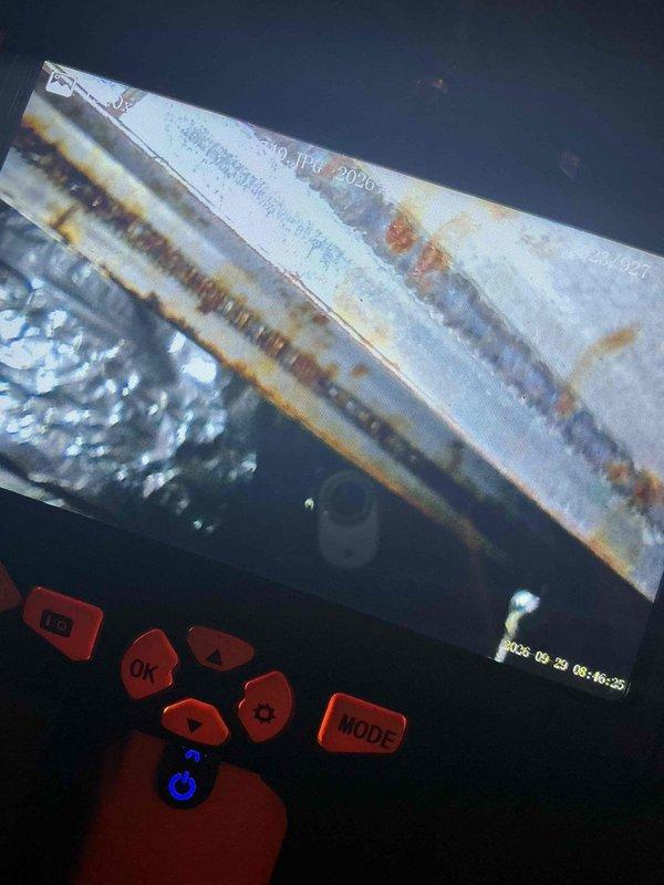Responded to no heat call on 24-year-old furnace. Found stuck gas valve preventing ignition; manually freed valve to restore temporary operation. During inspection, discovered elevated carbon monoxide levels and identified crack in heat exchanger using borescope camera. Documented visible corrosion and structural damage to heat exchanger with inspection photos showing rust streaking and compromised metal integrity. Advised immediate furnace replacement due to safety hazards from cracked heat exchanger and CO concerns, as well as age of unit beyond serviceable life expectancy.