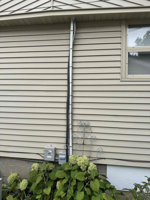 Completed follow-up service call to address attic air handler condensate drainage issue that could not be resolved during previous visit due to insufficient pitch. Successfully installed new drain line with proper slope to ensure adequate gravity drainage. Routed condensate line from attic unit through interior space and terminated at exterior wall of residence. Performed leak test by introducing water into drain pan and verified complete drainage with no leaks at connections or along pipe run. System now draining properly with appropriate pitch maintained throughout drain line installation.