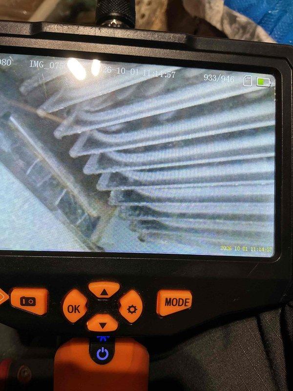 Responded to service call for AC system running with unusual noises and burning odor. Upon inspection, diagnosed failing blower motor, defective capacitor, and contaminated blower wheel. Borescope inspection revealed compromised secondary heat exchanger, presenting a safety hazard. Red-tagged furnace due to heat exchanger failure and provided customer with repair options and replacement quote.