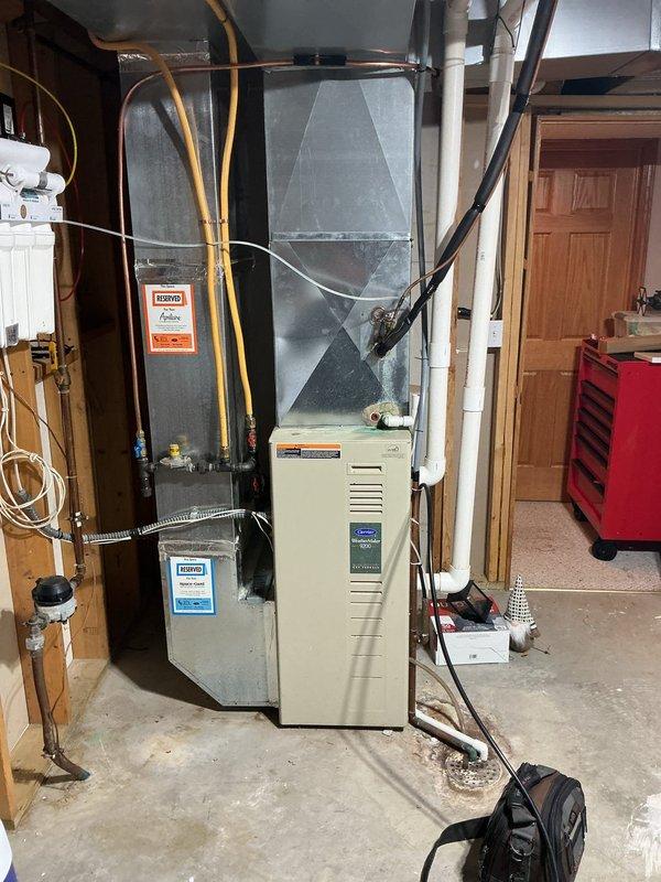 Responded to service call for AC system running with unusual noises and burning odor. Upon inspection, diagnosed failing blower motor, defective capacitor, and contaminated blower wheel. Borescope inspection revealed compromised secondary heat exchanger, presenting a safety hazard. Red-tagged furnace due to heat exchanger failure and provided customer with repair options and replacement quote.