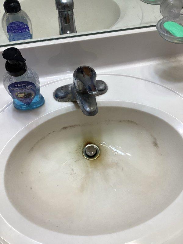 Responded to service call for leaking toilet and lavatory faucet in upstairs hallway bathroom. Upon inspection, identified failed fill valve and handle assembly in toilet tank, along with severely corroded lavatory faucet requiring full replacement. Removed and replaced defective toilet fill valve and flush handle with new components. Removed corroded lavatory faucet and installed new single-handle Moen faucet assembly. Tested all fixtures for proper operation and verified no leaks present. All repairs completed successfully with fixtures functioning as designed.