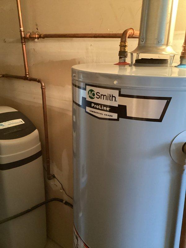 Responded to service call for water discoloration and brown spots appearing on laundry, with additional complaints of foul odor from hot water throughout the home. Upon inspection, diagnosed the issue as a failed anode rod in the AO Smith ProLine water heater. Removed the deteriorated anode rod and installed a new replacement rod to restore water quality and eliminate odor issues.