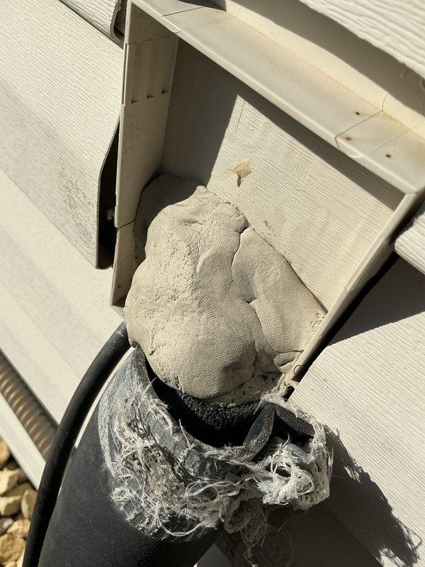 Responded to service call for Amana air conditioning system. Upon arrival, inspected exterior refrigerant line set and identified deteriorated putty seal requiring replacement. Removed old thumb gum sealant from line set penetration point and applied fresh putty to properly seal refrigerant lines against exterior wall, preventing moisture intrusion and maintaining system integrity.