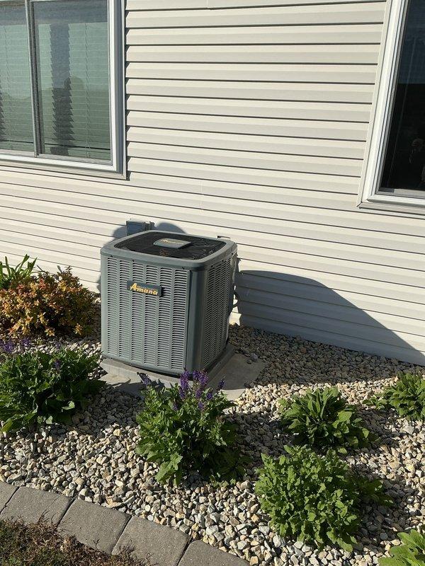 Responded to service call for Amana air conditioning system. Upon arrival, inspected exterior refrigerant line set and identified deteriorated putty seal requiring replacement. Removed old thumb gum sealant from line set penetration point and applied fresh putty to properly seal refrigerant lines against exterior wall, preventing moisture intrusion and maintaining system integrity.