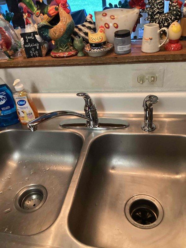 Responded to service call for leaking kitchen faucet and water heater issues. Upon inspection, determined the kitchen faucet was beyond repair due to failed sprayer mechanism and internal damage. Removed existing faucet assembly and installed new replacement unit, completing all supply line connections and testing for proper operation and leak-free performance. Additionally, identified a faulty temperature and pressure relief valve on the tanked water heater that was actively leaking. Removed the defective T&P valve and installed new valve, ensuring proper threading and seal. Verified all repairs were functioning correctly with no leaks present at kitchen sink or water heater upon completion.