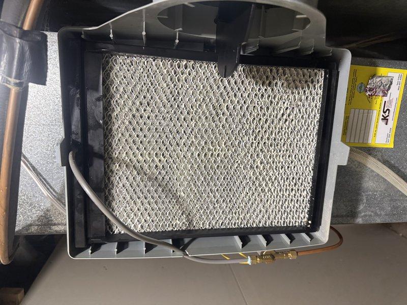 Responded to service call for UV light malfunction, zone system issues, and humidifier concerns on dual-zone HVAC system. Upon inspection, verified both zones operating correctly with no functional issues. Found humidifier water panel heavily soiled and UV bulb burnt out. Replaced defective UV ballast/bulb assembly and installed new humidifier water panel, restoring full system operation.