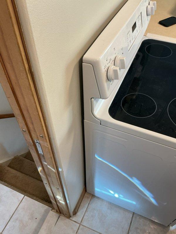 Installed a dedicated 20-amp circuit with new outlet for refrigerator to meet current electrical code requirements. Relocated existing stove outlet by adjusting its position on the wall, allowing the electric range to fit flush against the wall without obstruction. All work completed with power verified and appliances tested for proper operation.