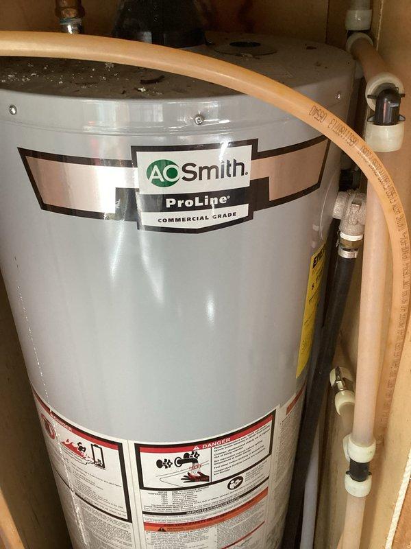 Provided estimate for temporary disconnection and removal of AO Smith ProLine commercial grade tanked water heater to facilitate flooring replacement in utility room due to water heater leakage. Scope includes disconnecting water supply lines, gas line, and all associated plumbing connections, relocating unit from installation space, and reinstalling water heater with full reconnection of all utilities after new flooring installation is complete.