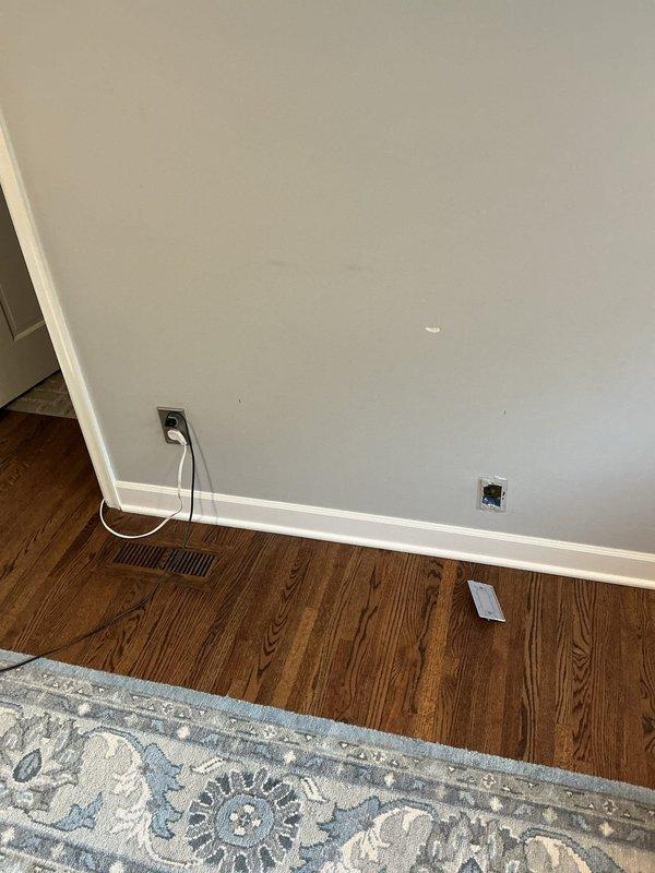 Relocated existing electrical outlet and installed additional outlet in living room to accommodate upcoming built-in cabinet installation. Outlets were strategically positioned per specifications to ensure proper placement for cabinetry and maintain code compliance.