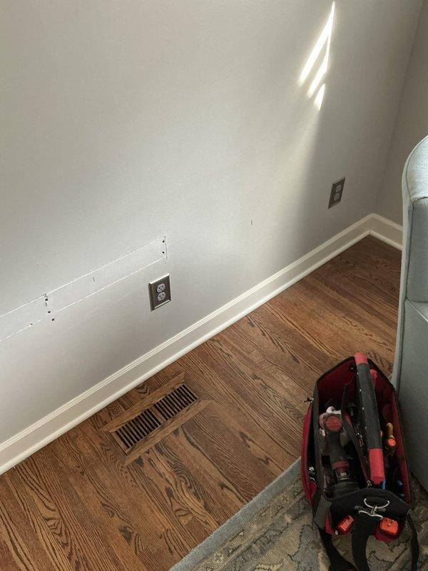 Relocated existing electrical outlet and installed additional outlet in living room to accommodate upcoming built-in cabinet installation. Outlets were strategically positioned per specifications to ensure proper placement for cabinetry and maintain code compliance.