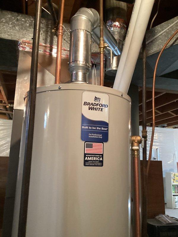 Removed existing 49-gallon natural gas atmospheric vent water heater after draining and disconnecting all connections. Installed new Bradford White 40-gallon natural gas atmospheric vent water heater with proper venting configuration. Added new drip leg to gas supply line and installed 1/2" ball valve on cold water inlet for isolation capability. Made all necessary water and gas connections, filled tank, and successfully lit pilot. Verified proper operation of all components and system functionality upon completion.