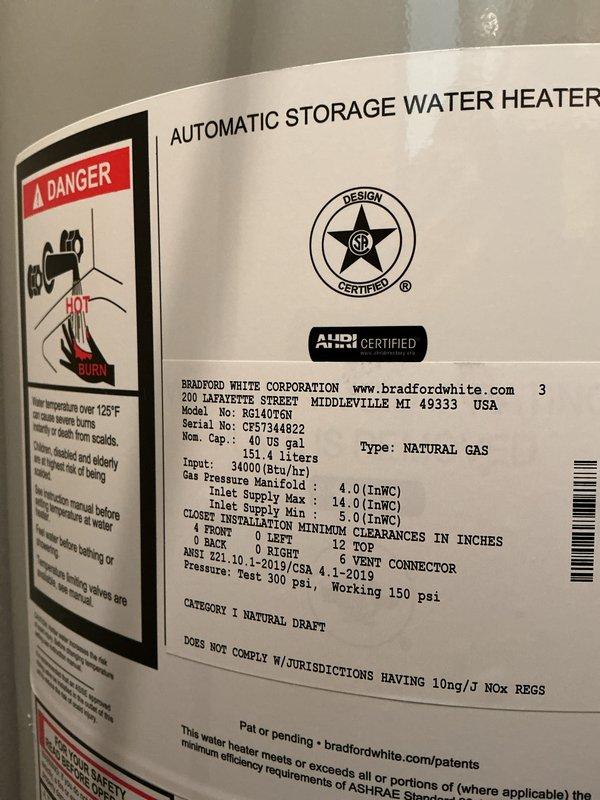 Completed installation of a 40-gallon Bradford White atmospheric natural gas water heater, model RG140T6N, with 40,000 BTU/hr input rating. Connected copper supply and discharge piping, installed galvanized vent pipe, and verified proper integration with existing water softener system. All connections tested and unit operational.