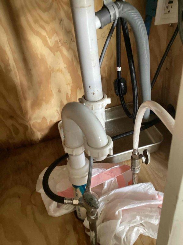 Responded to a reported kitchen faucet leak and upon inspection discovered the actual source was a leaking S-trap drain assembly beneath the kitchen sink. The leak was caused by a loose compression nut on the drain fitting. Tightened the compression nut to proper torque specifications and tested the drainage system to verify complete resolution of the leak with no further water seepage detected.