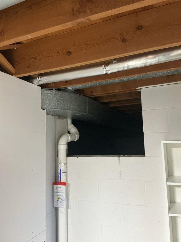 Performed on-site evaluation for wall-mounted electric vehicle charger installation in residential garage. Assessed existing electrical infrastructure including main breaker panel and unfinished basement area with exposed joists providing clear access to garage wall. Developed installation plan to junction new home run circuit in existing junction box located in garage, then run approximately 15 feet of conduit along garage wall to customer's preferred charger mounting location. Documented existing conditions including electrical panel configuration and available routing paths through basement ceiling space. Provided detailed estimate for complete EV charger installation including materials and labor.