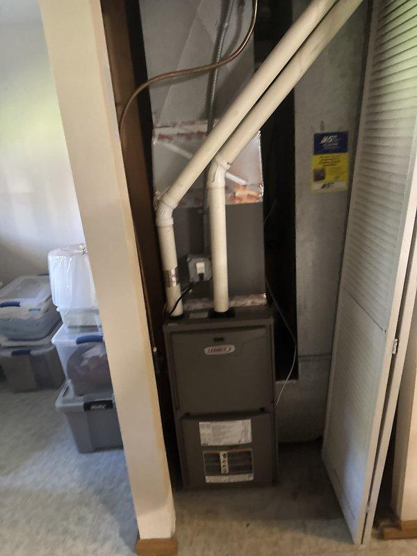 Responded to water intrusion issue affecting Lennox furnace exhaust system during rainfall. Upon inspection, identified compromised roof sealant at flue pipe penetration allowing water infiltration. Resealed roof penetration points, removed wasp nest obstruction from exhaust piping, and performed full system operational test confirming no water damage to furnace components and proper venting function.