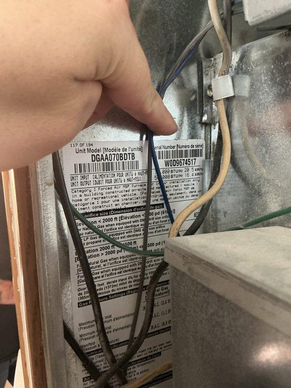 Responded to service call for furnace making grinding noise prior to ignition. Diagnosed inducer motor as source of noise and discovered large accumulation of dust and debris in inducer motor housing. Cleaned inducer motor housing thoroughly, removed all debris, and replaced blower motor capacitor to restore proper system operation.