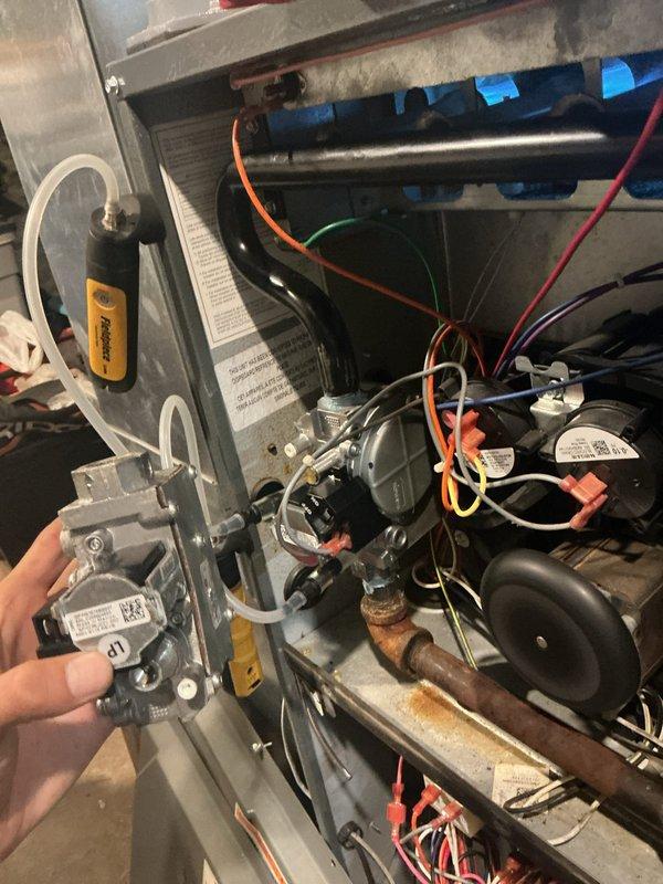 # HVAC Service - No Heat <10 years old

Responded to no heat call for furnace not turning on. Upon arrival, performed diagnostic testing to identify the source of the heating system failure. Utilized multimeter and pressure testing equipment to evaluate gas delivery and electrical components within the unit.

Diagnosis revealed a failed gas valve preventing proper fuel delivery to the burner assembly. The gas valve showed no response to electrical signals from the control board and failed to open when commanded by the thermostat. This component failure resulted in complete loss of heating capability.

Proceeded with gas valve replacement by first shutting off gas supply to the unit and verifying zero pressure at the valve. Disconnected pressure sensing tubes and electrical connections from the failed valve. Removed mounting hardware and extracted the defective gas valve from the furnace cabinet. 

Installed new gas valve assembly, ensuring proper alignment and secure mounting to manufa