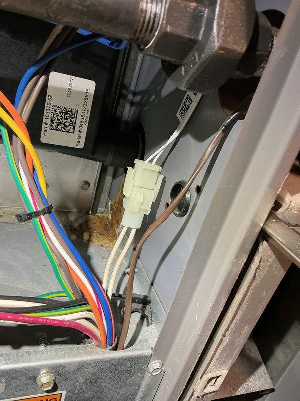 Responded to water leak from 12-year-old furnace and identified failed condensate plug on collector box as source of leak. Replaced defective collector box plug to resolve active water discharge. Observed significant corrosion present on drip pan and internal metal surfaces due to prolonged moisture exposure, though primary leak was successfully addressed with plug replacement.