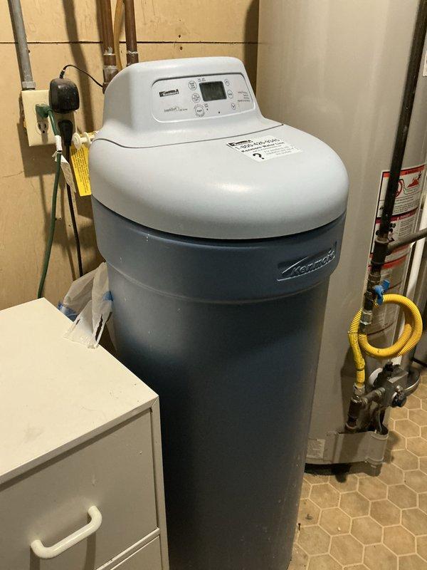 Responded to service call for water softener issue. Upon arrival, diagnosed plugged relief valve on existing water softener system. Assessed approximately 20-year-old single-piece Kenmore water softener unit and determined repair may not be cost-effective given age and condition of equipment. Provided comprehensive estimates for both repair of existing unit and replacement with new single-piece Water-Right Impression Series water softener system. Documented existing Morton-branded equipment installation with photographs showing control head, tank body, and plumbing connections in utility room setting.