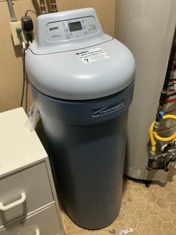 Responded to service call for water softener issue. Upon arrival, diagnosed plugged relief valve on existing water softener system. Assessed approximately 20-year-old single-piece Kenmore water softener unit and determined repair may not be cost-effective given age and condition of equipment. Provided comprehensive estimates for both repair of existing unit and replacement with new single-piece Water-Right Impression Series water softener system. Documented existing Morton-branded equipment installation with photographs showing control head, tank body, and plumbing connections in utility room setting.
